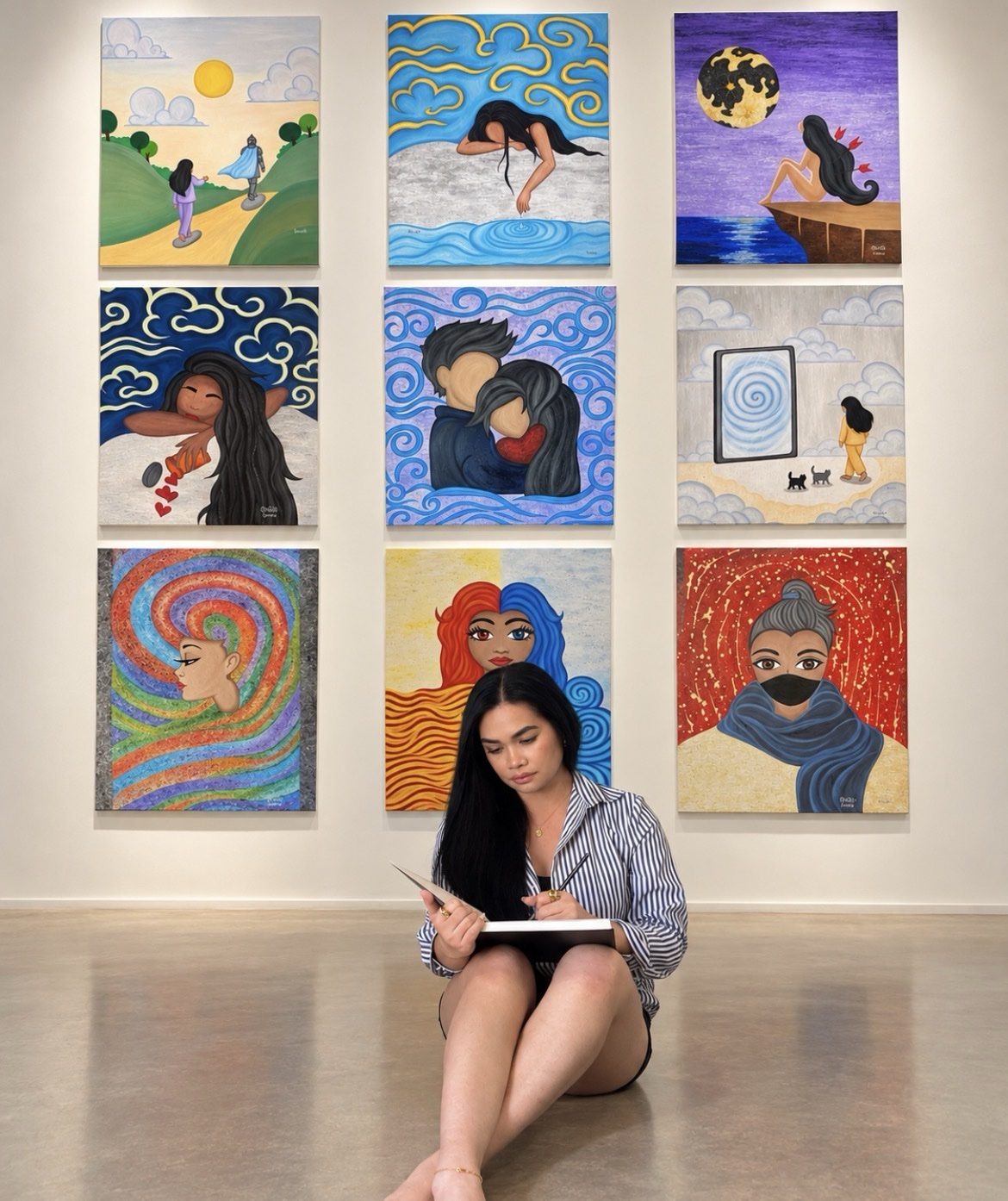 Karena writing before her Collection 2 wall of paintings